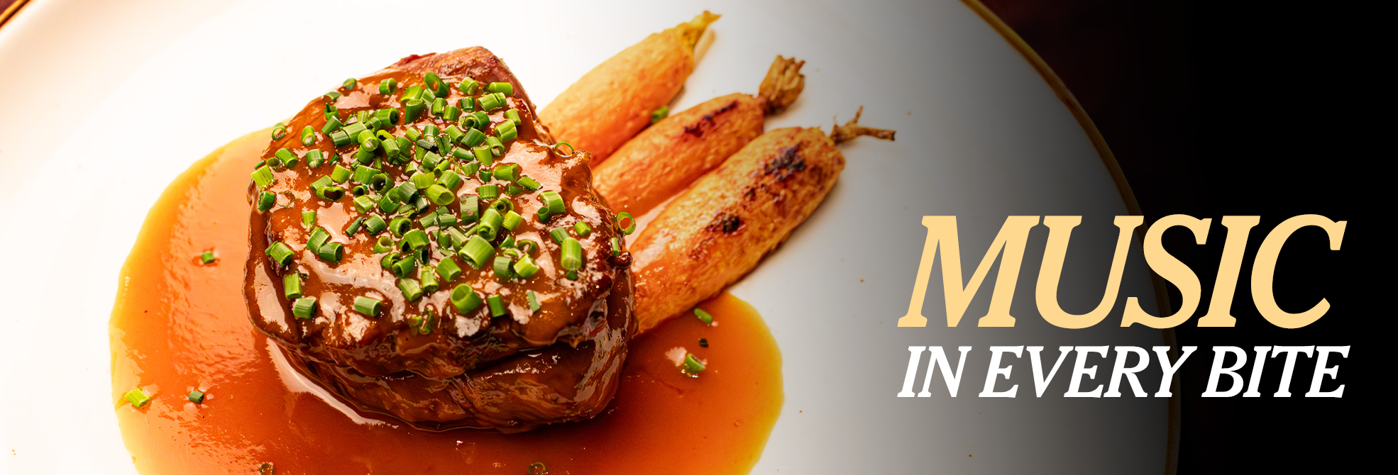 A gourmet steak topped with chopped chives and rich brown sauce is plated beside roasted carrots on a white dish, capturing the essence of world-class dining. To the right, large, elegant text reads, 