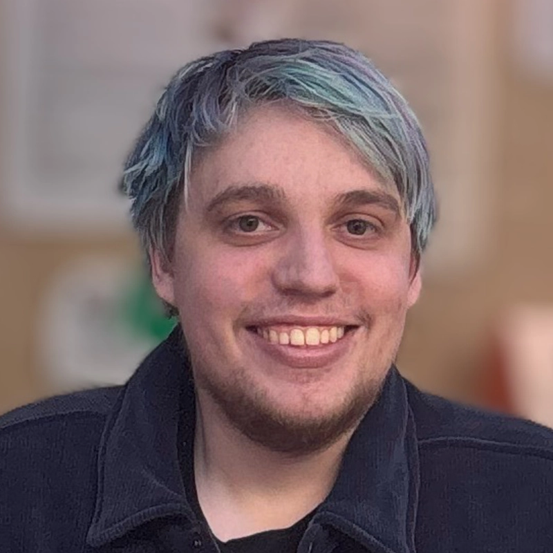 A man smiling at the camera, captured by photographer Ella Sodam Yoon.