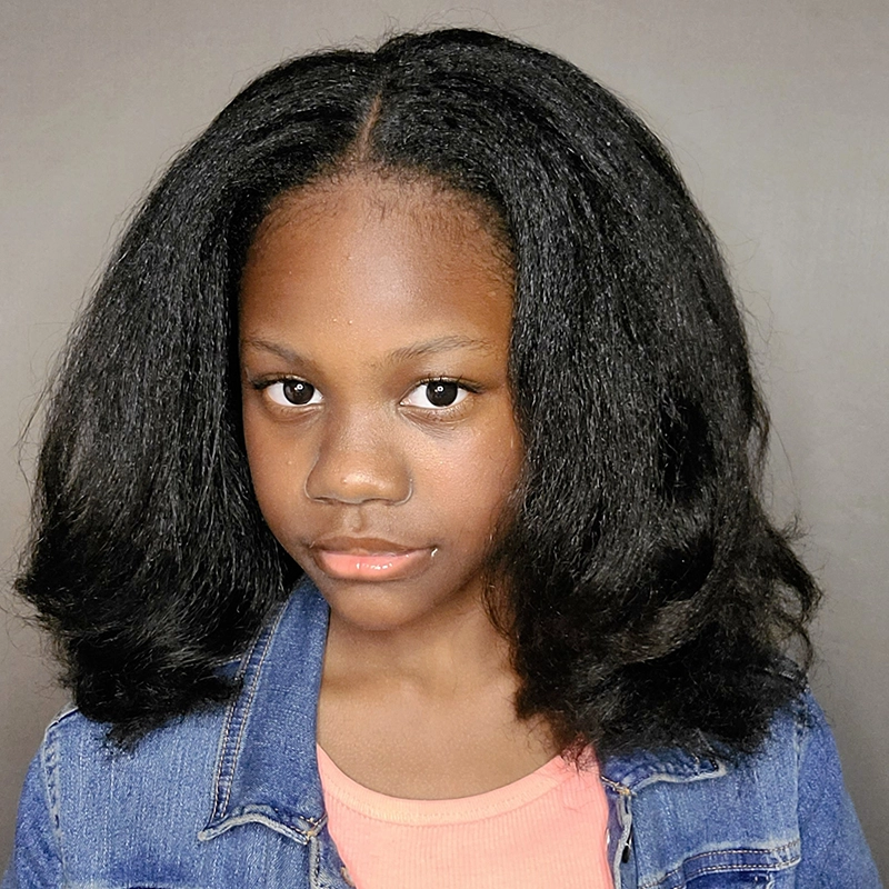 A young girl, Summer Rae Daney, with medium-dark skin and straight, shoulder-length black hair is wearing a denim jacket over a peach-colored top. She looks directly at the camera with a neutral expression, standing against a plain gray background.