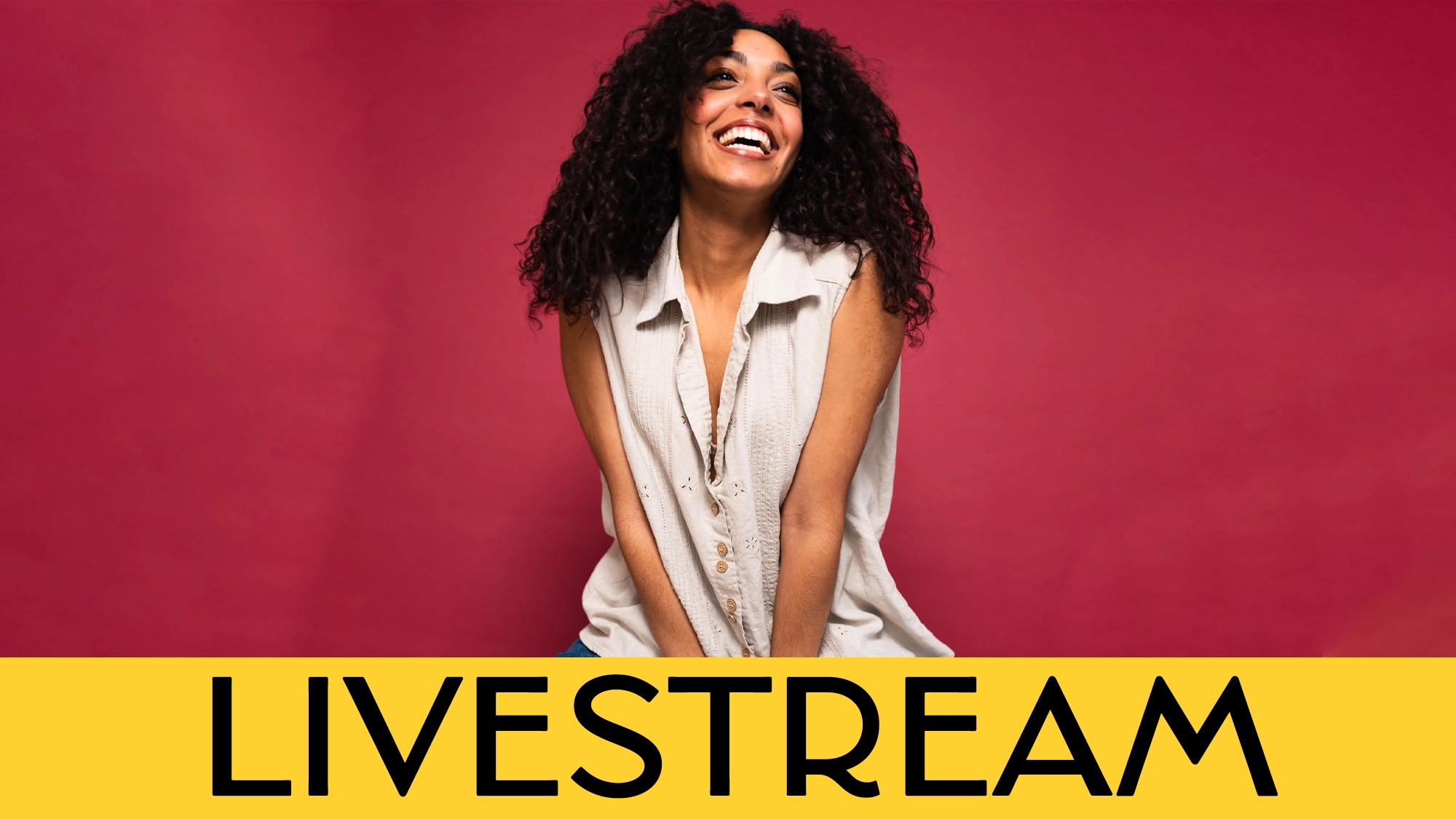 A smiling woman with curly hair sits against a plain red background. She wears a sleeveless beige shirt and looks upward. Across the bottom, a yellow banner displays 