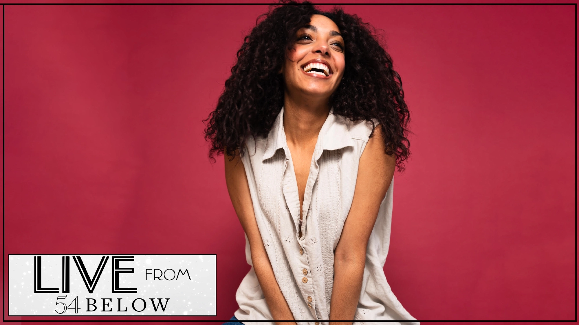 A woman with curly dark hair smiles joyfully, looking upward. She wears a sleeveless, light-colored buttoned shirt and sits against a bright pink background. In the lower left corner, a “LIVE FROM 54 BELOW” logo hints at an exciting LIVESTREAM event.