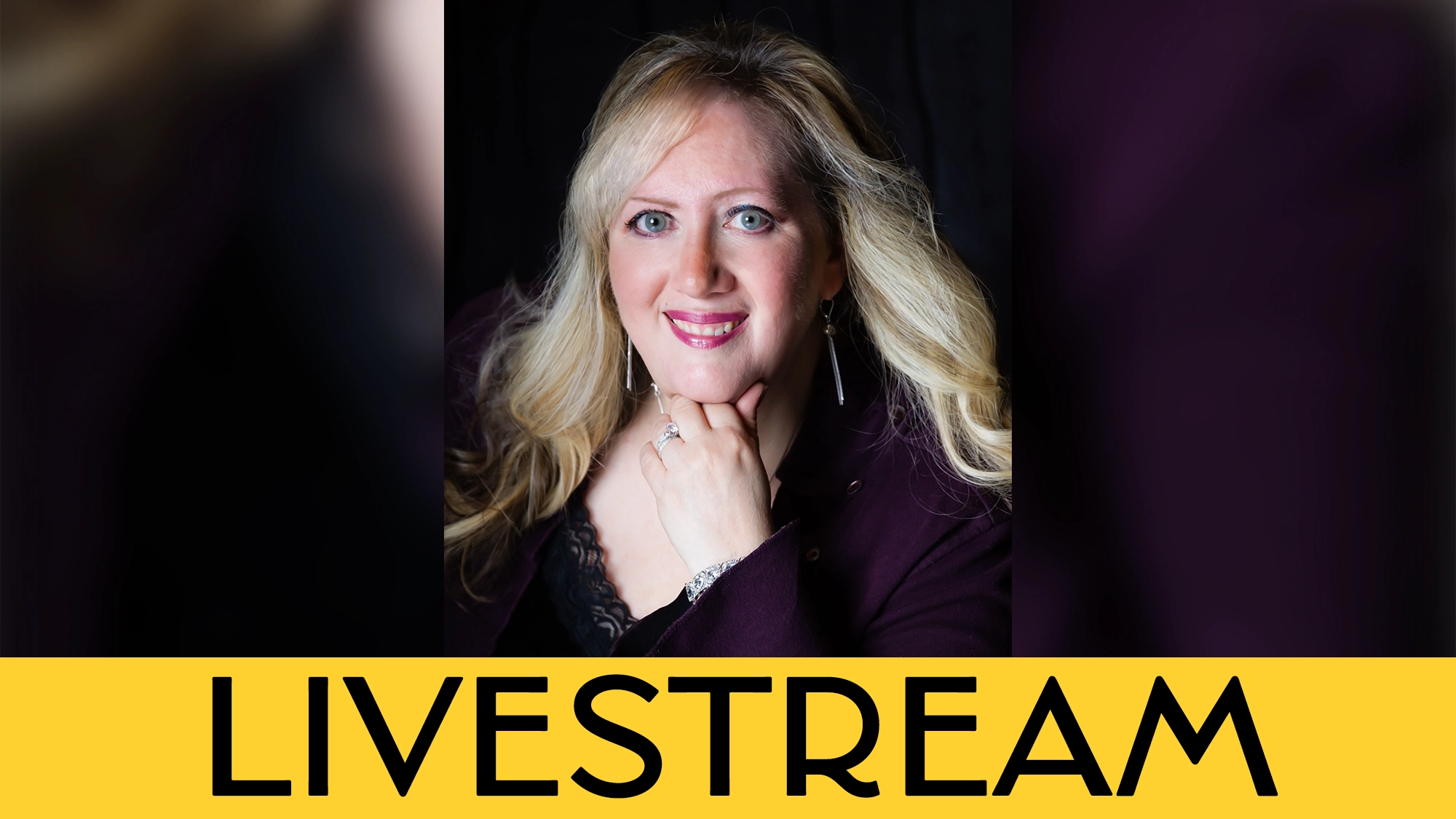 A woman with long blonde hair and light skin smiles at the camera, wearing a dark jacket and earrings. Her hand rests near her chin. The background is black. A bold yellow banner below highlights 
