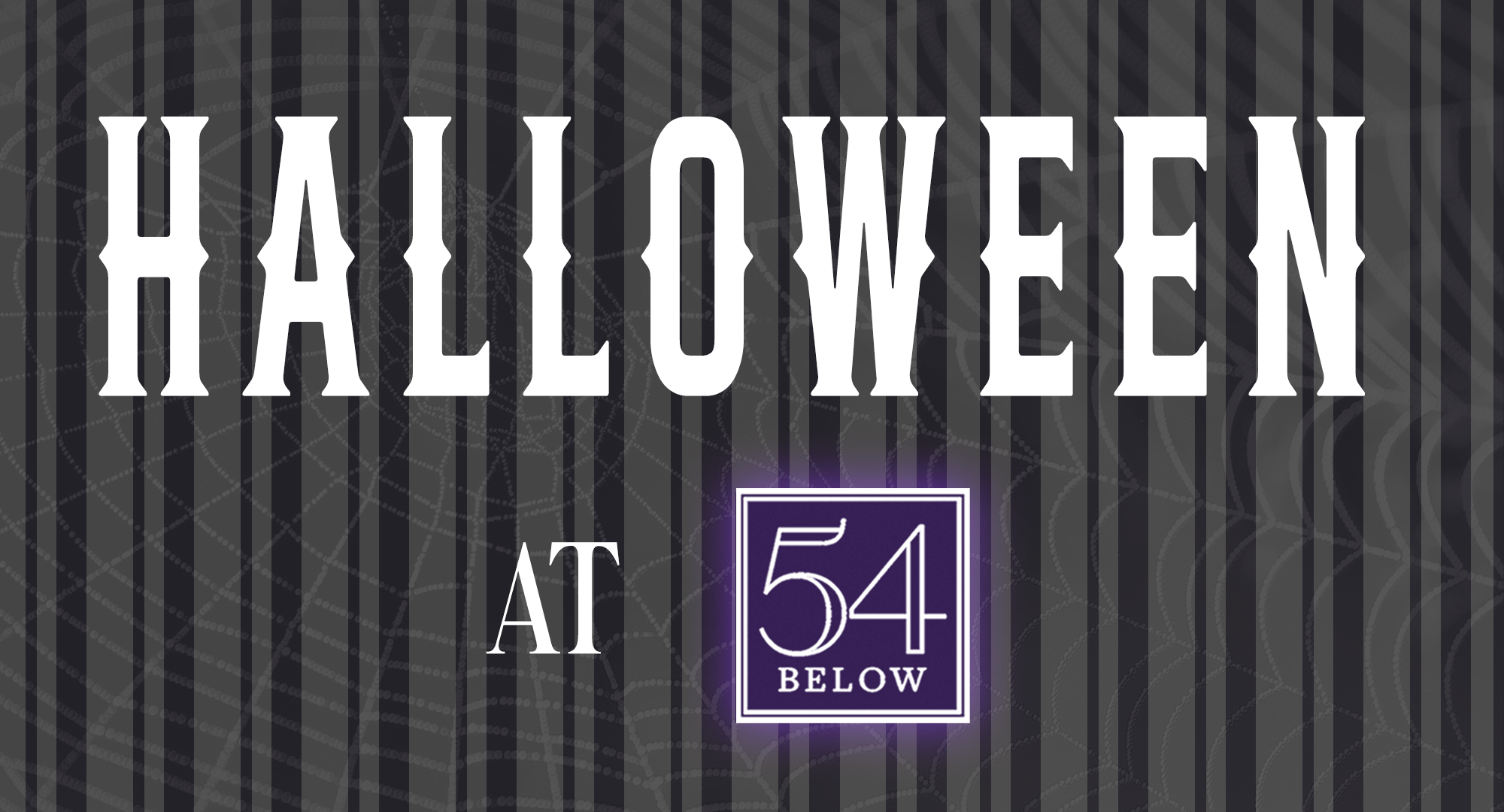 The image has a dark, striped background with a subtle spiderweb pattern. Bold white text reads “HALLOWEEN” above smaller text “AT,” followed by a purple logo that says “54 BELOW” in white letters within a square border.