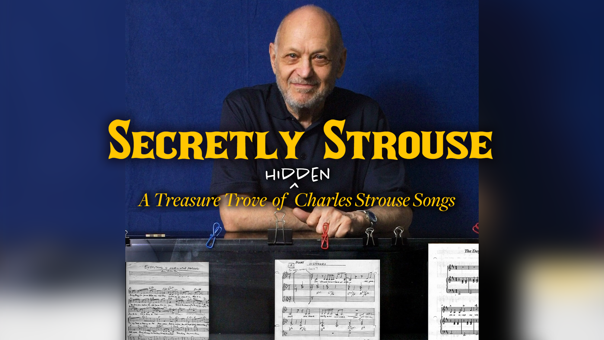 A bald man with a beard smiles, leaning on a black piano covered with sheet music. Bold yellow text reads “Secretly Strouse,” highlighting hidden Charles Strouse songs. Subtitle: “A Treasure Trove of Charles Strouse Songs.”.