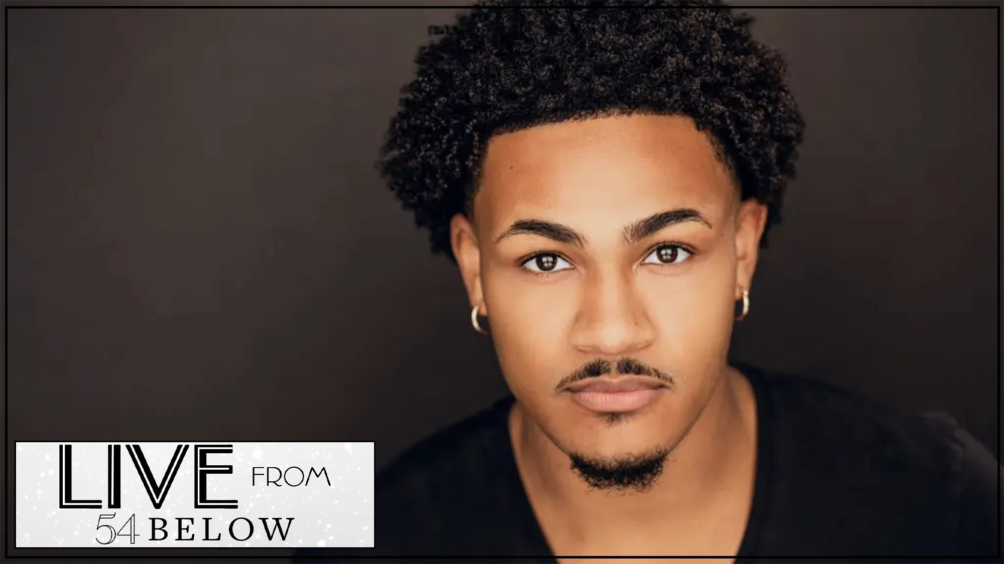 Aaron Patterson show page A young man with short curly hair, thin mustache, and goatee stares confidently at the camera. He wears small hoop earrings and a black shirt. The background is dark. In the corner, a graphic reads