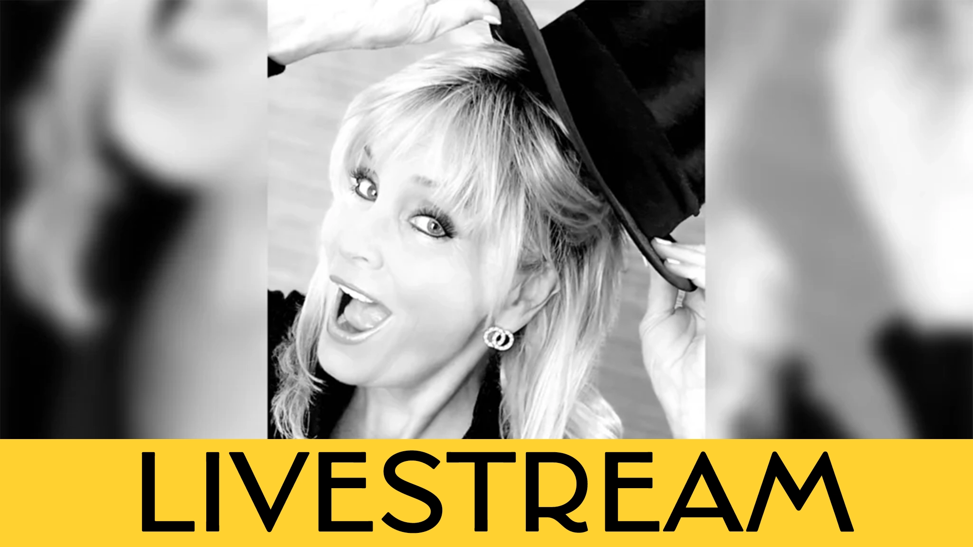 Black-and-white photo of a smiling woman with light hair, wearing hoop earrings, tilting a top hat with one hand. The word 