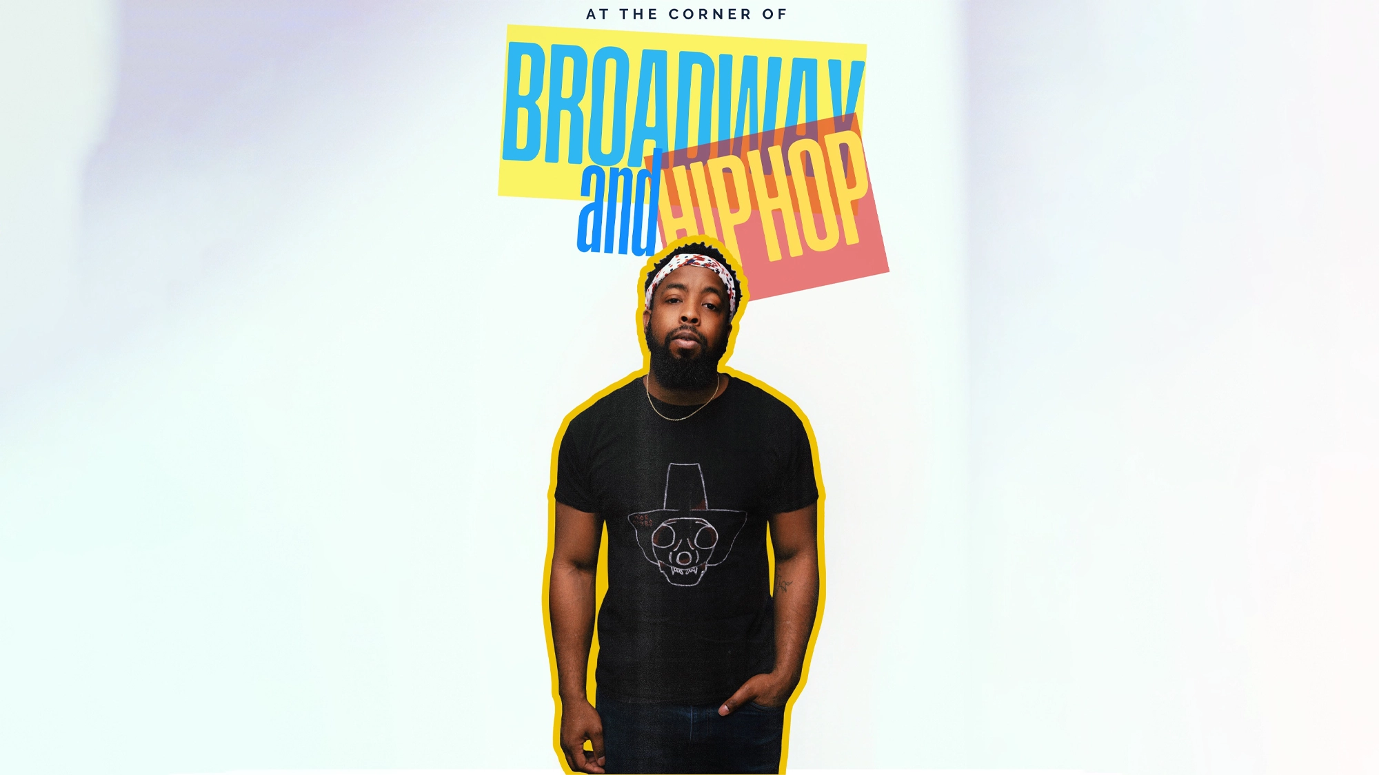 At the Corner of Broadway and Hip-Hop - Show Image A man with a beard, wearing a black t-shirt with a face drawing, stands against a light backdrop. Above him, colorful text reads