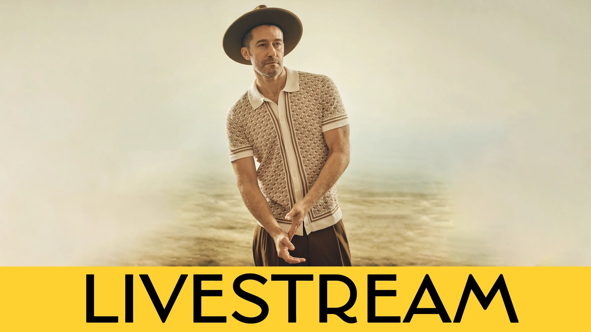 LIVE Matthew Morrison Calendar A man in a patterned polo shirt, dark pants, and wide-brimmed hat stands in a neutral, misty background. He has facial hair and a neutral expression. Across the bottom,