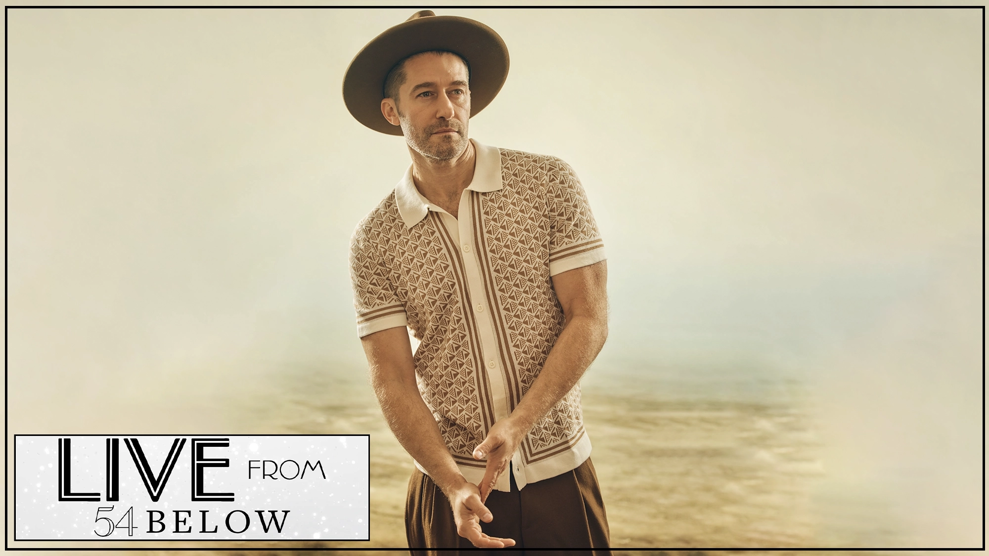 LIVE Matthew Morrison A man in a patterned short-sleeve knit shirt and wide-brimmed hat stands outdoors against a blurred, sandy background. In the bottom left, a “LIVE FROM 54 BELOW” logo appears, teasing a special LIVESTREAM of Rhythms & Revelations.
