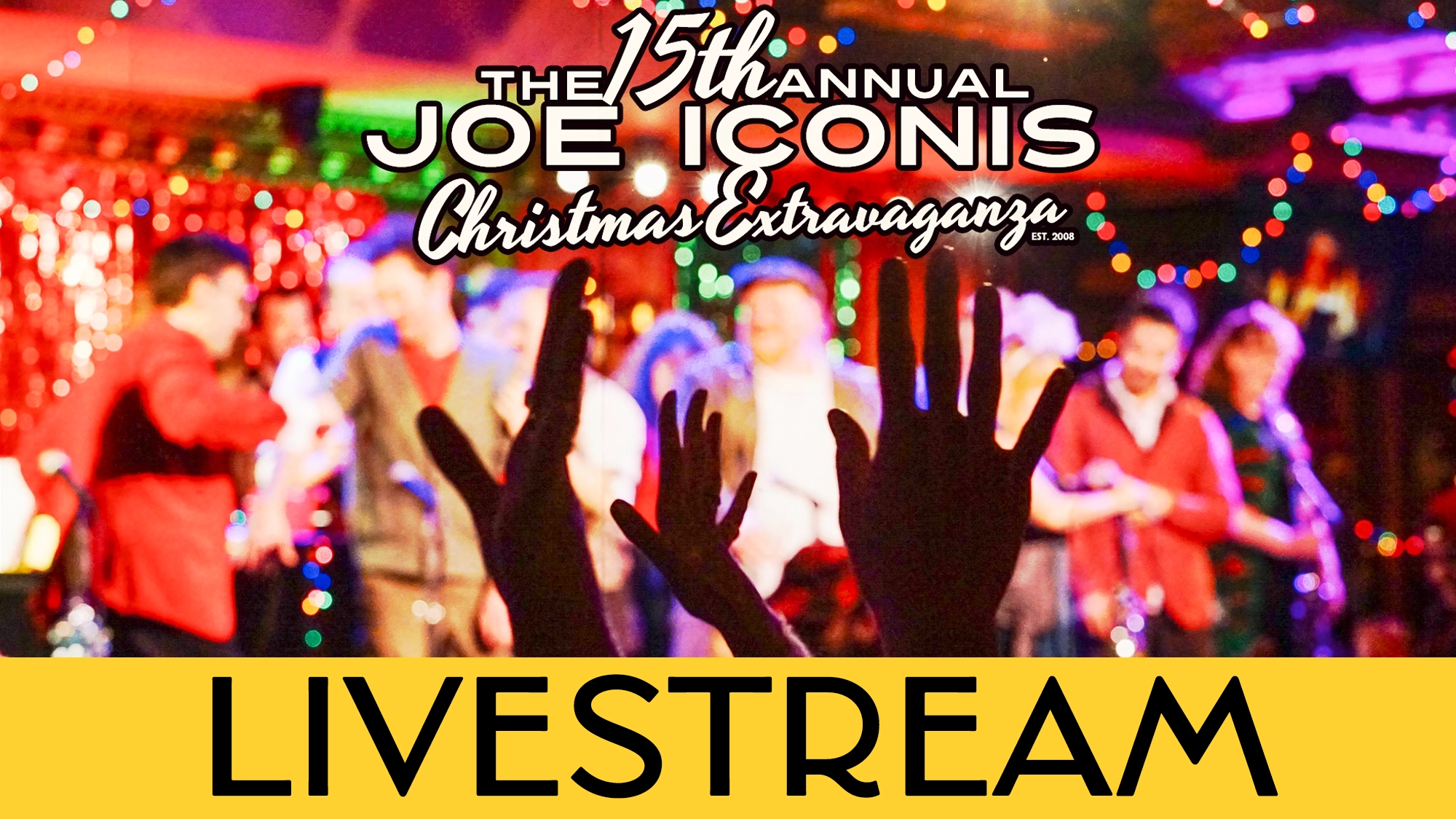A raised hand silhouettes against a festive stage as performers dazzle in the background. “The 15th Annual Joe Iconis Christmas Extravaganza” LIVESTREAM shines in bold over the lively, holiday-lit scene.
