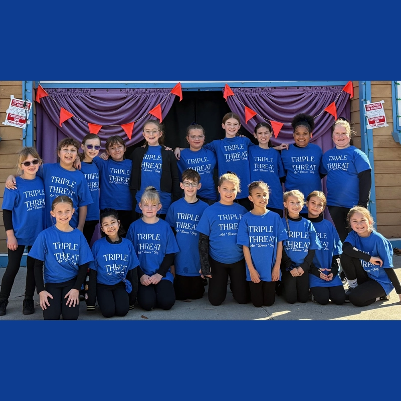 A group of 19 kids wearing matching blue 