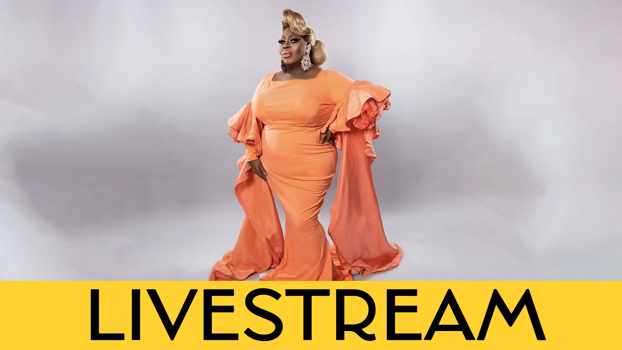 A person poses confidently in an elegant, bright orange gown with dramatic sleeves and train, inspired by Latrice Royale. They have styled blonde hair and bold makeup. The background is light gray, with a yellow 