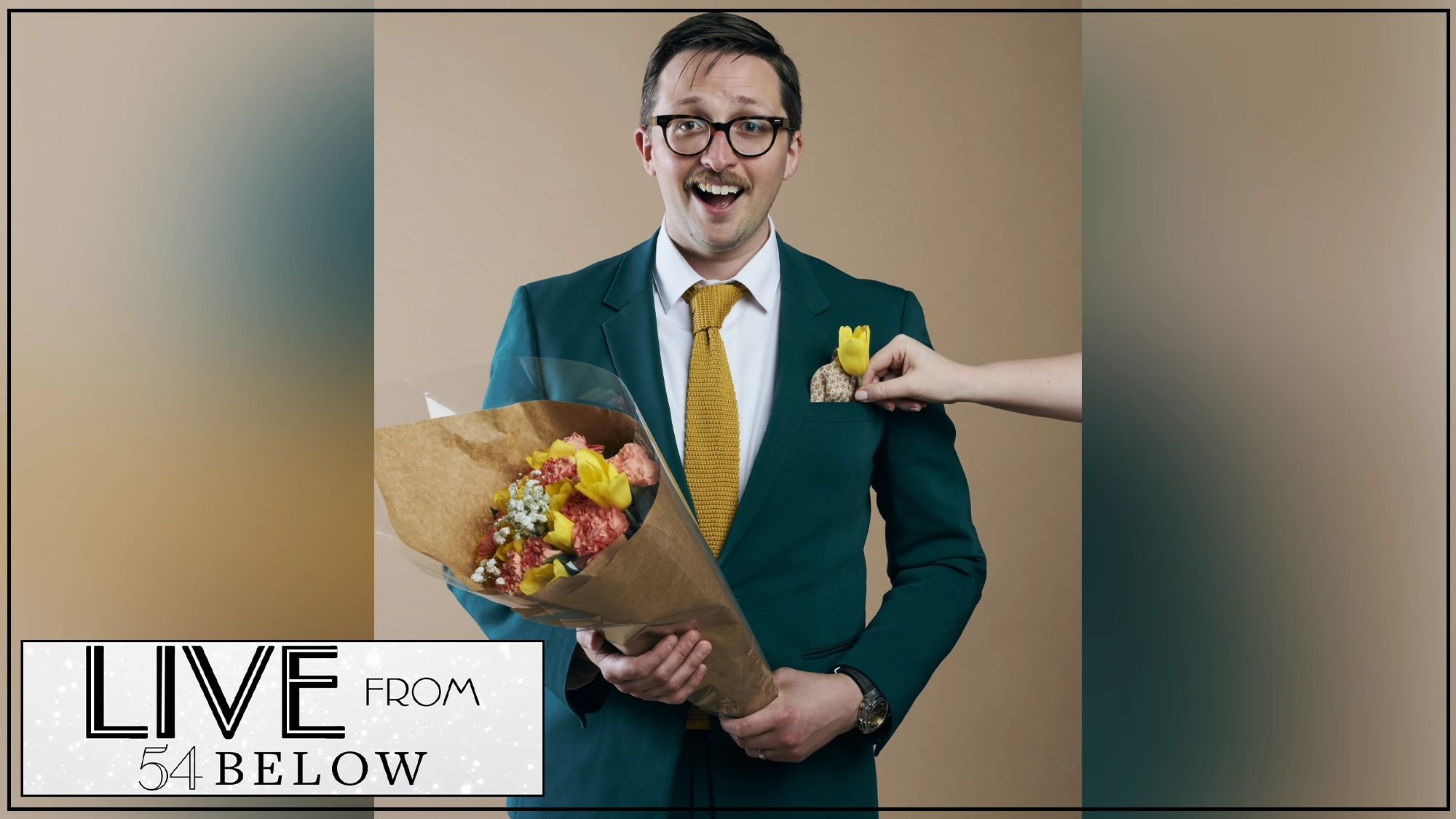 A smiling man in glasses and a teal suit, identified as Will Roland, holds a bouquet of flowers. He wears a yellow tie as a hand adds a yellow flower to his pocket. The tan background features the 