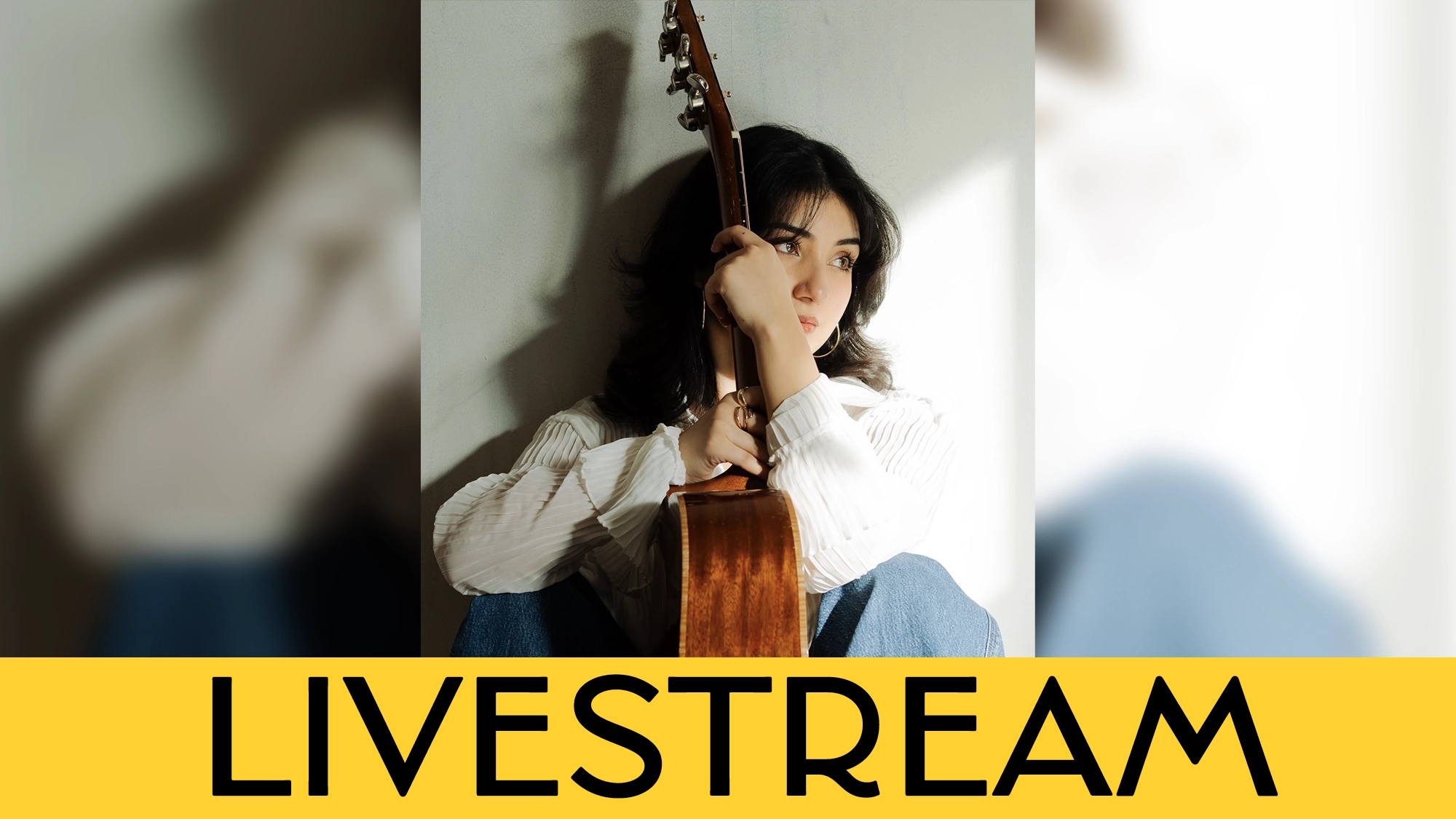 A woman with dark hair sits against a wall, holding an acoustic guitar upright and gazing thoughtfully to the side. A bold yellow banner at the bottom announces her upcoming LIVESTREAM in striking black capital letters.