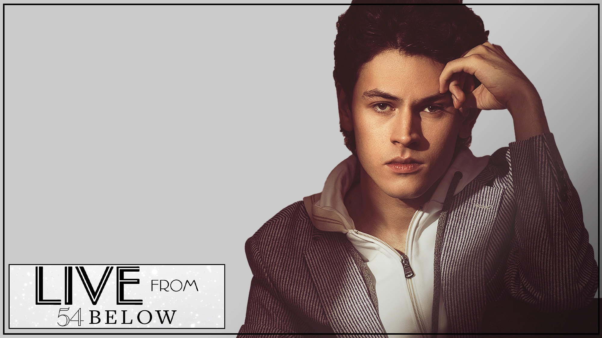 Casey Likes show page A young person with wavy dark hair in a striped jacket sits with one hand to their forehead. The background is gray. Bottom left text: